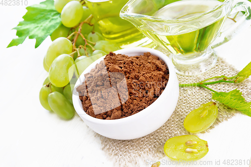 Image of Flour grape seed in bowl on light board