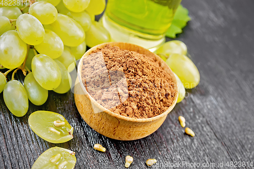 Image of Flour grape seed in bowl on wooden board