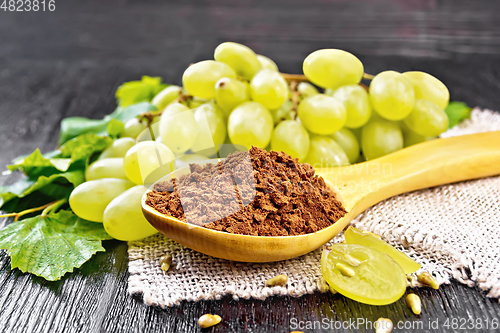 Image of Flour grape seed in spoon on board