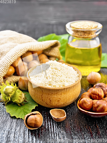 Image of Flour in bowl with nuts on wooden board