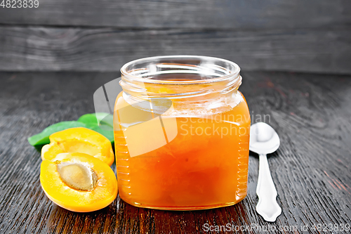 Image of Jam apricot in jar on wooden board