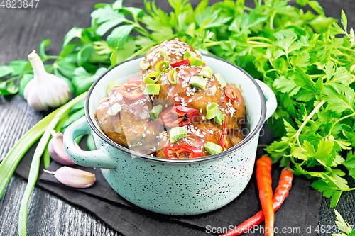 Image of Meatballs in sweet and sour sauce on black board