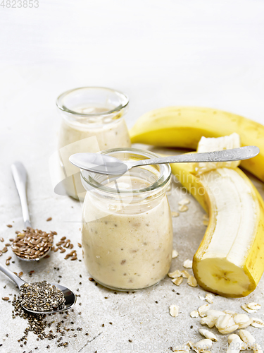 Image of Milkshake with chia and banana in jars on stone table