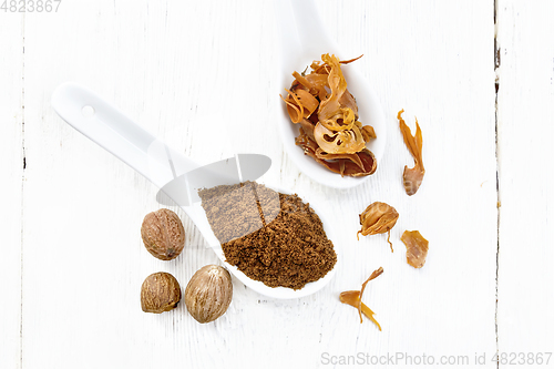 Image of Nutmeg ground and mace in spoons on light board top