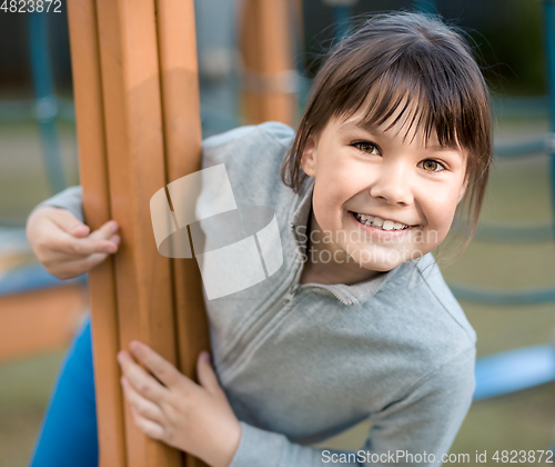 Image of Cute little girl is playing in playground