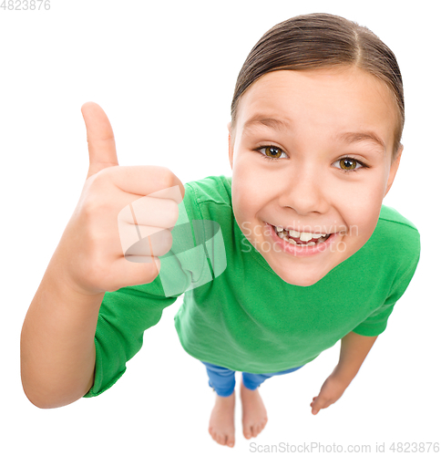 Image of Little girl is showing thumb up gesture