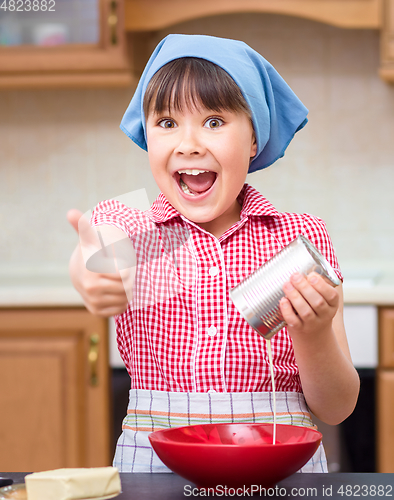 Image of Girl is cooking in kitchen