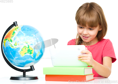 Image of Young girl is using tablet