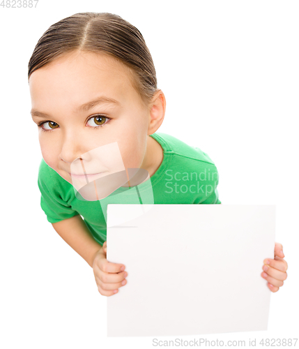 Image of Happy little girl is holding blank board