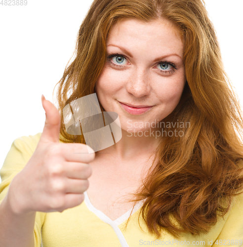 Image of Woman is showing thumb up gesture