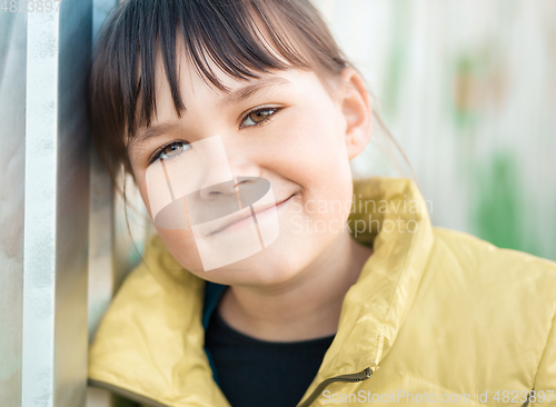 Image of Portrait of a girl leaning to the wall