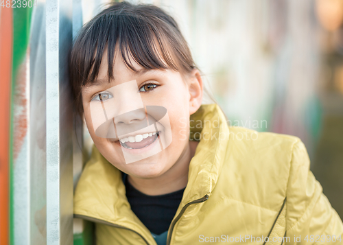 Image of Portrait of a girl leaning to the wall