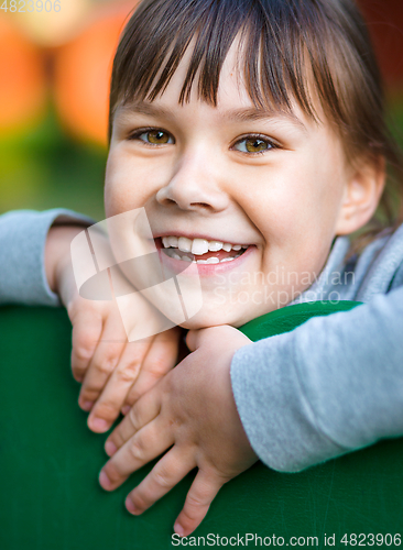 Image of Cute little girl is playing in playground