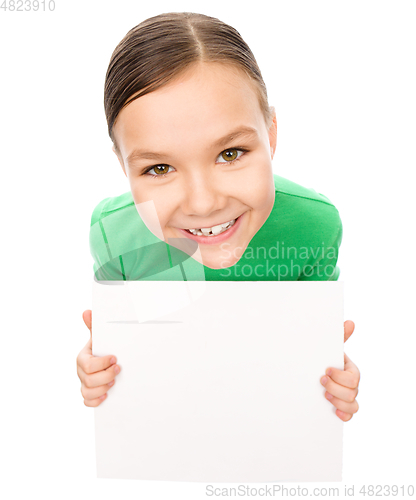 Image of Happy little girl is holding blank board