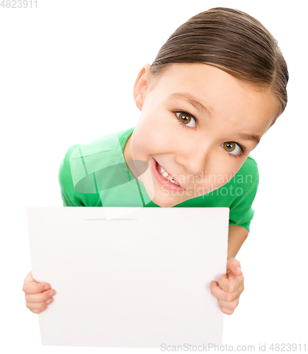 Image of Happy little girl is holding blank board