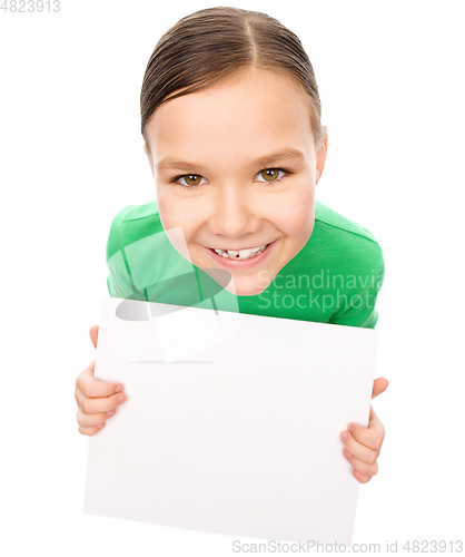 Image of Happy little girl is holding blank board