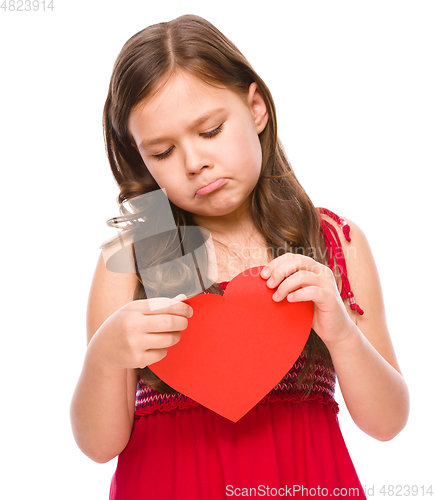 Image of Portrait of a sad little girl in red