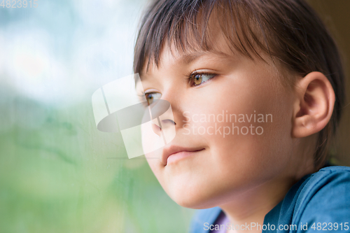 Image of Girl is looking through window