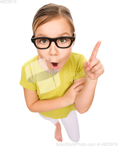 Image of Little girl is pointing up with index finger