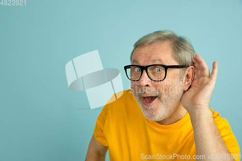 Image of Caucasian senior man\'s portrait isolated on blue studio background