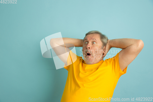 Image of Caucasian senior man\'s portrait isolated on blue studio background