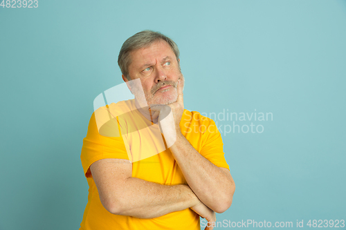 Image of Caucasian senior man\'s portrait isolated on blue studio background