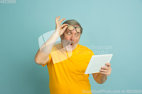 Image of Caucasian senior man\'s portrait isolated on blue studio background