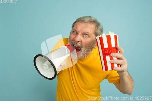 Image of Caucasian senior man\'s portrait isolated on blue studio background