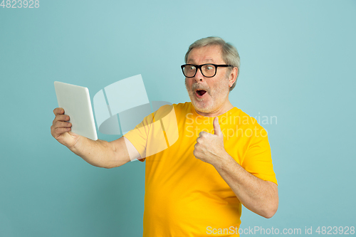 Image of Caucasian senior man\'s portrait isolated on blue studio background