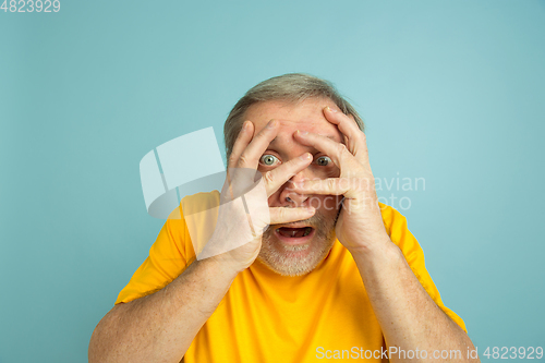 Image of Caucasian senior man\'s portrait isolated on blue studio background