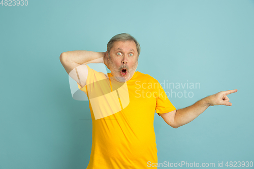 Image of Caucasian senior man\'s portrait isolated on blue studio background