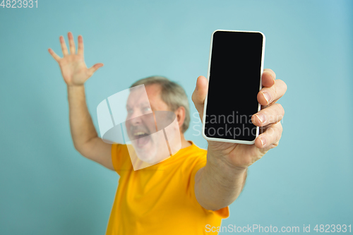 Image of Caucasian senior man\'s portrait isolated on blue studio background