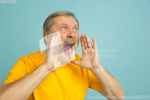 Image of Caucasian senior man\'s portrait isolated on blue studio background