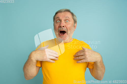 Image of Caucasian senior man\'s portrait isolated on blue studio background