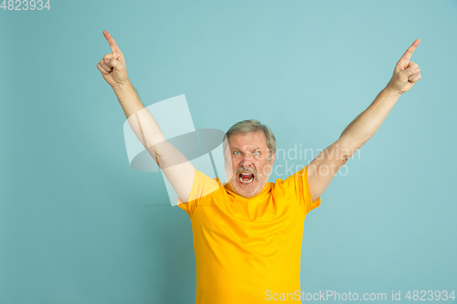 Image of Caucasian senior man\'s portrait isolated on blue studio background