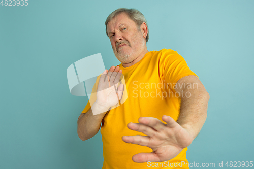 Image of Caucasian senior man\'s portrait isolated on blue studio background