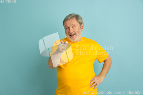 Image of Caucasian senior man\'s portrait isolated on blue studio background