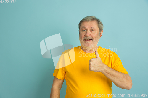 Image of Caucasian senior man\'s portrait isolated on blue studio background