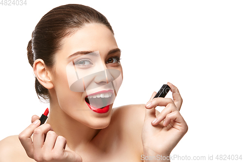 Image of girl applying red lipstick isolated on white