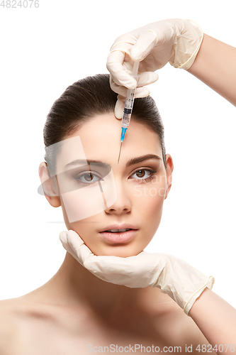 Image of girl getting face injection isolated on white