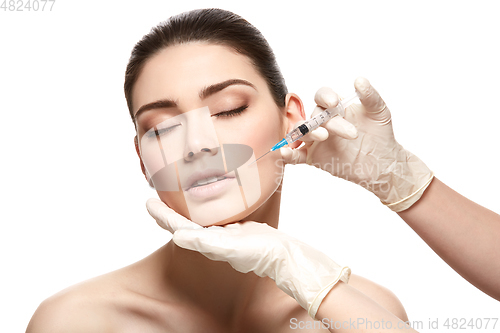 Image of girl getting face injection isolated on white