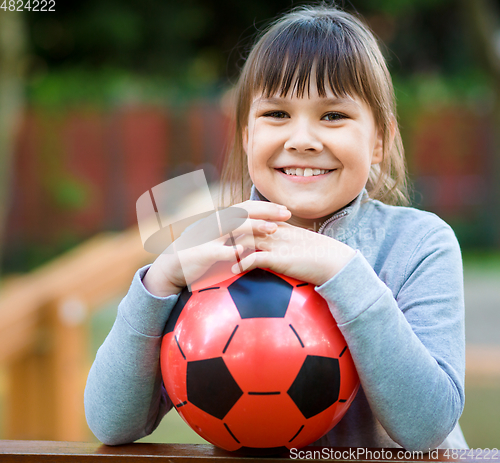 Image of Cute little girl is playing in playground