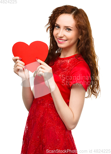 Image of Young woman holding red heart