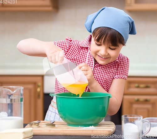 Image of Girl is cooking in kitchen