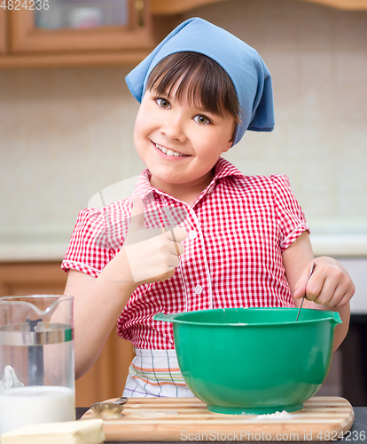 Image of Girl is cooking in kitchen