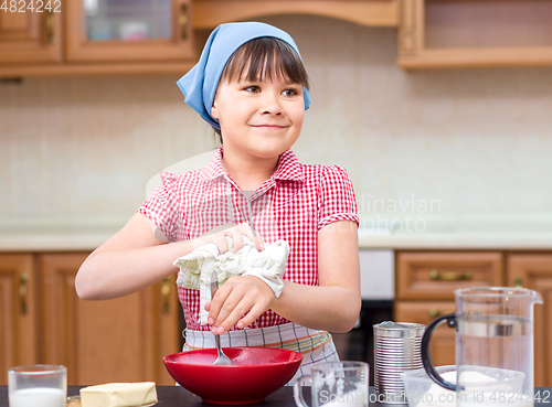 Image of Girl is cooking in kitchen