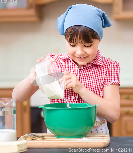 Image of Girl is cooking in kitchen