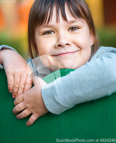 Image of Cute little girl is playing in playground