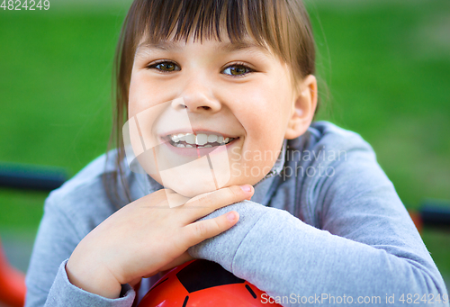 Image of Cute little girl is playing in playground