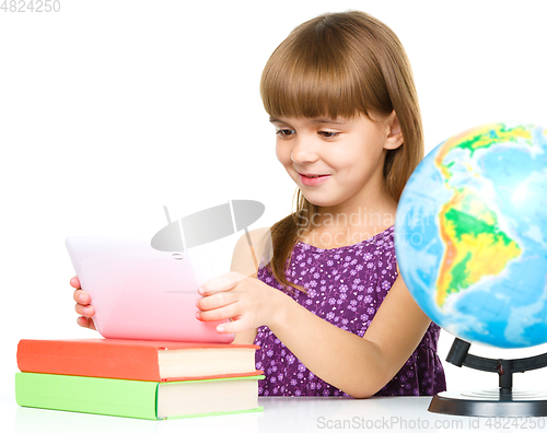 Image of Young girl is using tablet